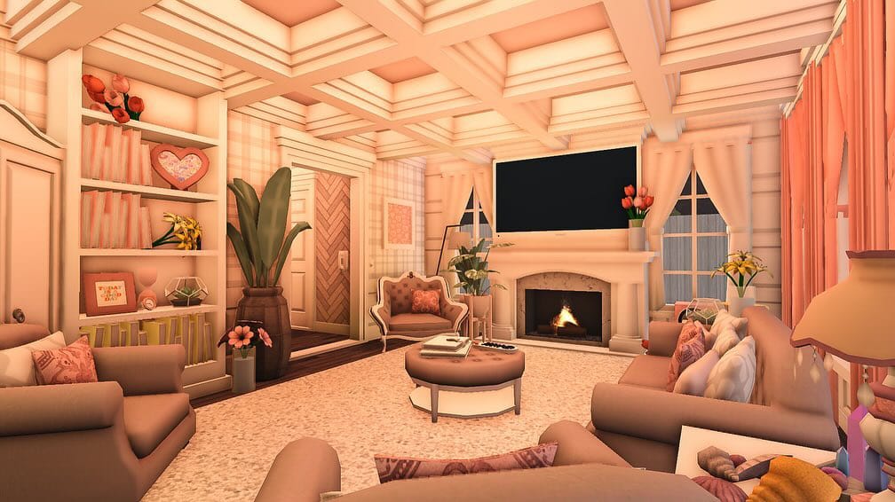 Bloxburg living room with blush pink decor, plush sofas, and a coquette aesthetic.