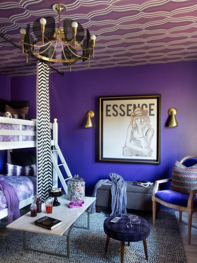 Teen bedroom with deep purple walls, a bunk bed, wavy patterned ceiling, and gold accents.