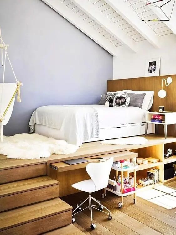 Teen bedroom with an elevated bed and built-in workspace underneath.