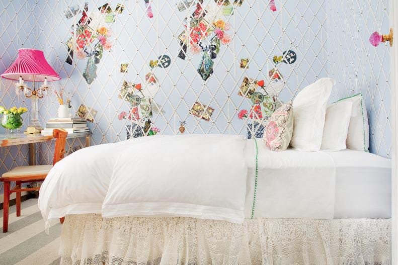 Whimsical teen bedroom with pastel colors, creative wallpaper, pink lamp, and patterned pillows.