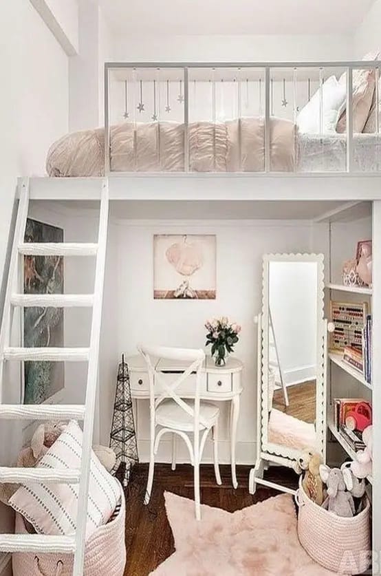 Loft bedroom with a bed above a study area, decorated in pastel colors and soft lighting.