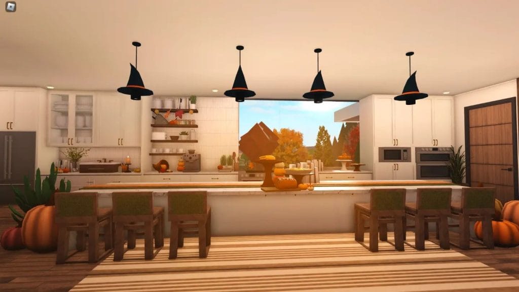 Modern kitchen with warm wood tones, autumn decor, and large windows.