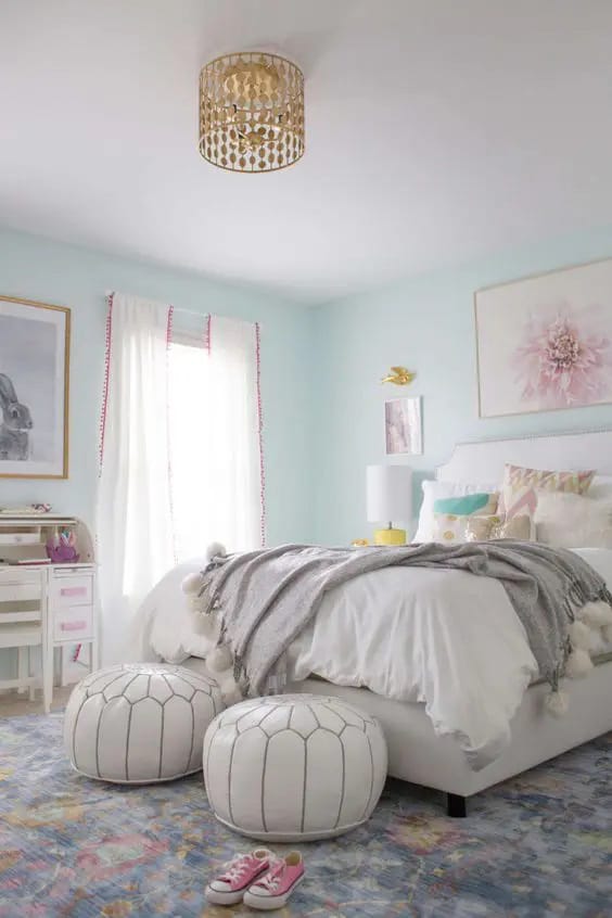 Serene bedroom with a pastel color palette, simple decor, and cozy bedding.