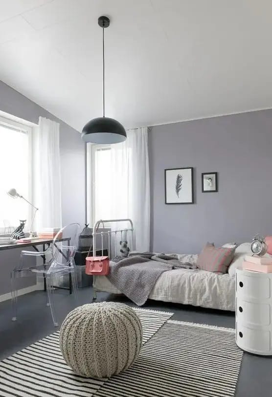 Minimalist gray teen bedroom with modern furniture and a chunky knit pouf.