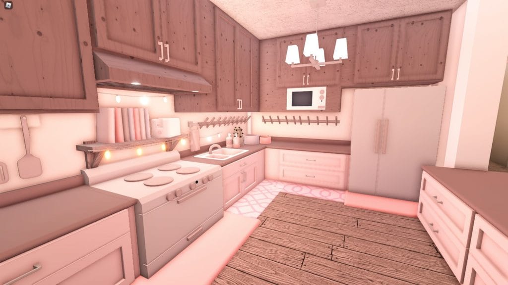 A cozy Bloxburg kitchen with wood tones, soft pink accents, and charming lighting.