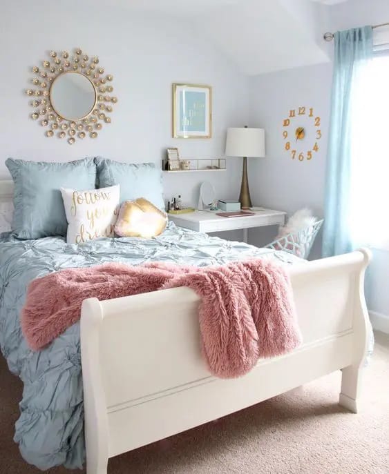 Glamorous blue and pink teen bedroom with gold decor and plush bedding.