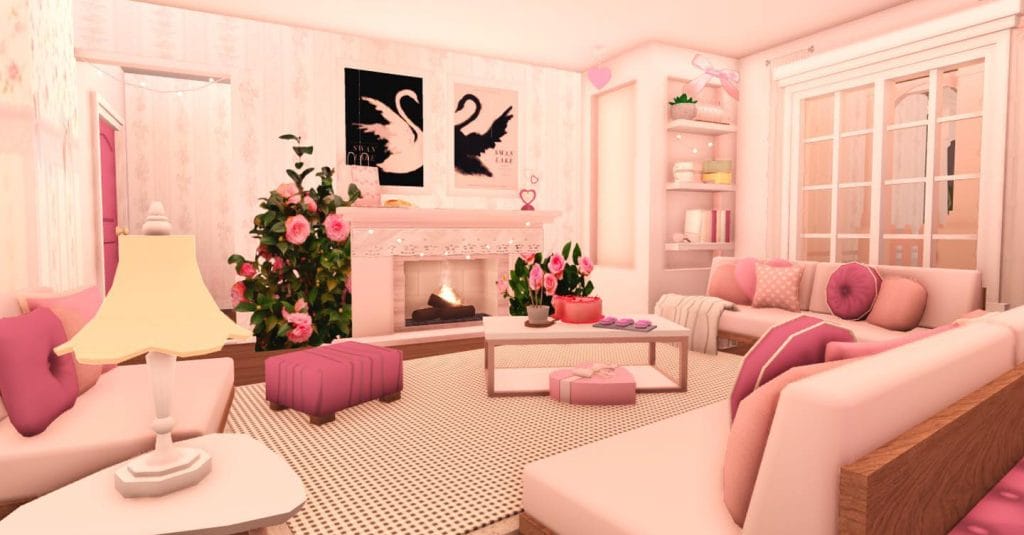 Romantic Bloxburg living room with pink decor, floral accents, and a cozy fireplace