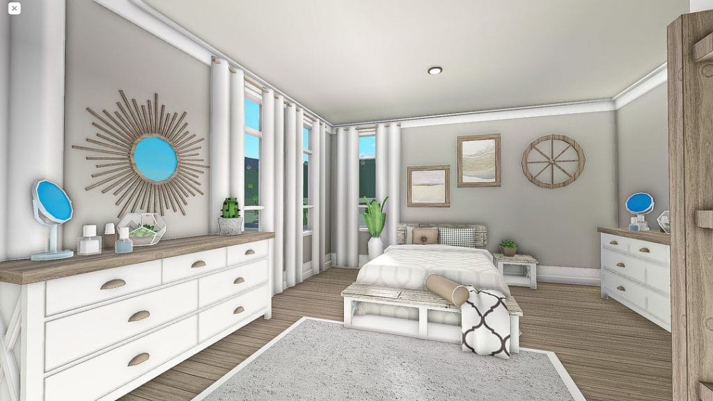 A coastal-inspired bedroom with light-colored furniture and airy drapery.