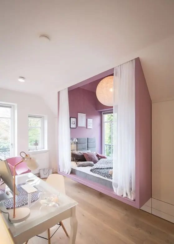 Cozy nook with lavender accents, sheer curtains, and a built-in bed.