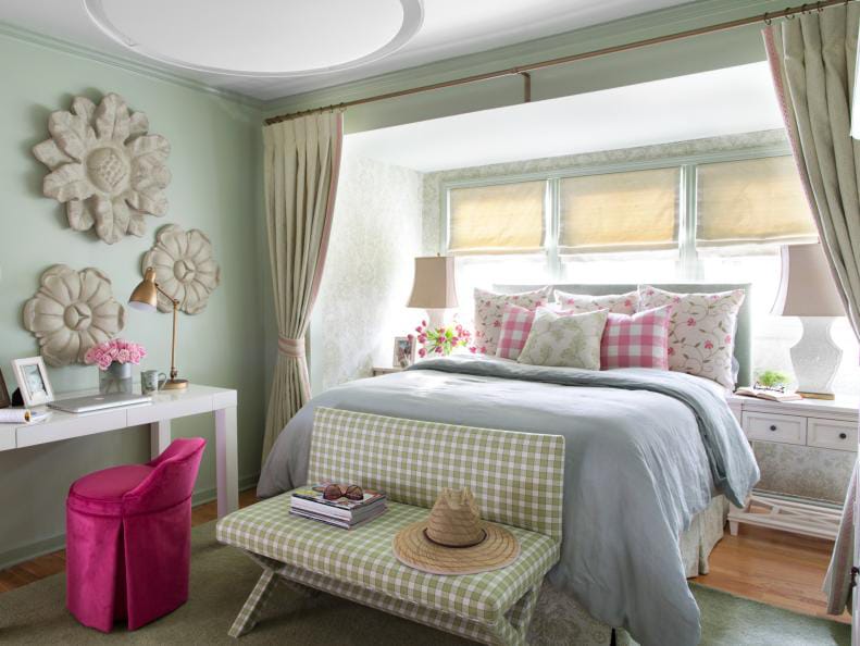 Vintage-style teen bedroom with green walls, floral decor, and pastel bedding.