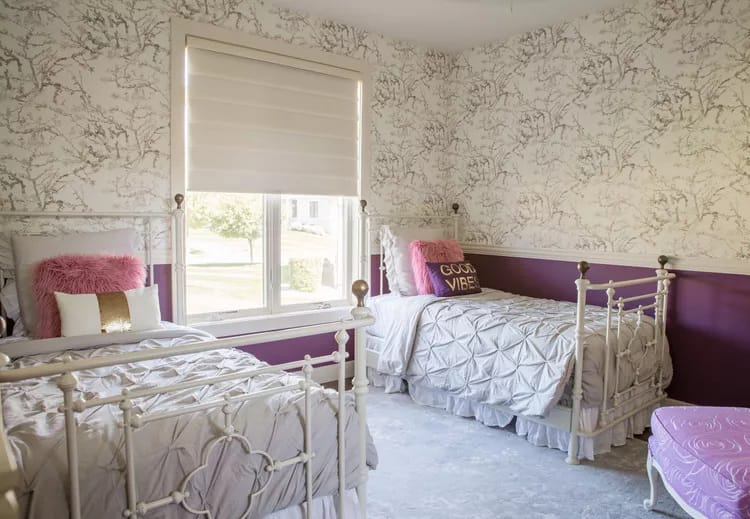 Room with twin beds, coordinated decor, and bold wall patterns.