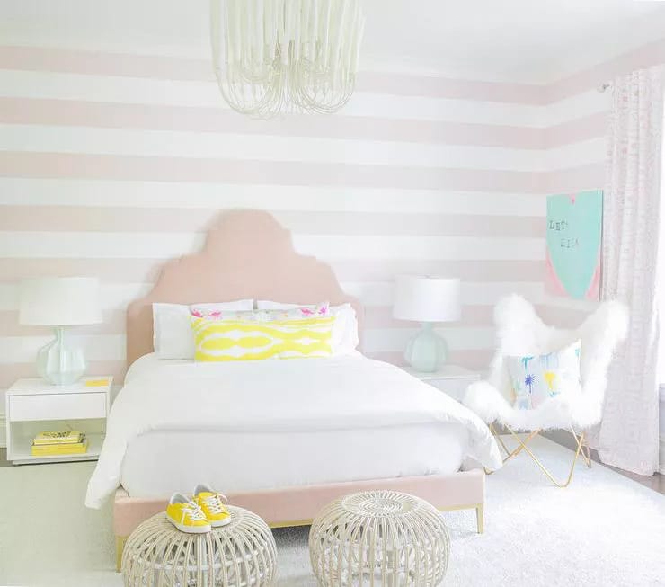 Room with soft pastel colors, striped walls, and bright yellow accents.