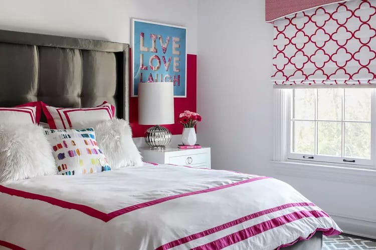 Room with bold pink and white design, geometric patterns, and "Live Love Laugh" artwork.