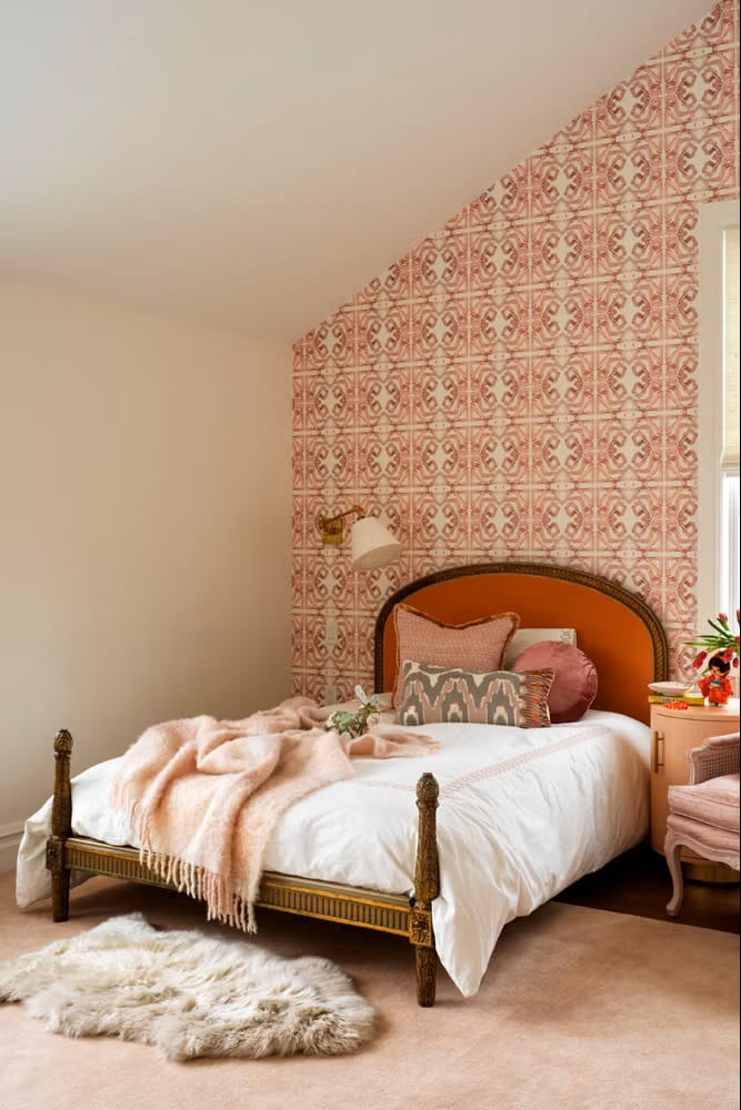 Warm and cozy room with rustic elegance, featuring patterned wallpaper and soft textures.