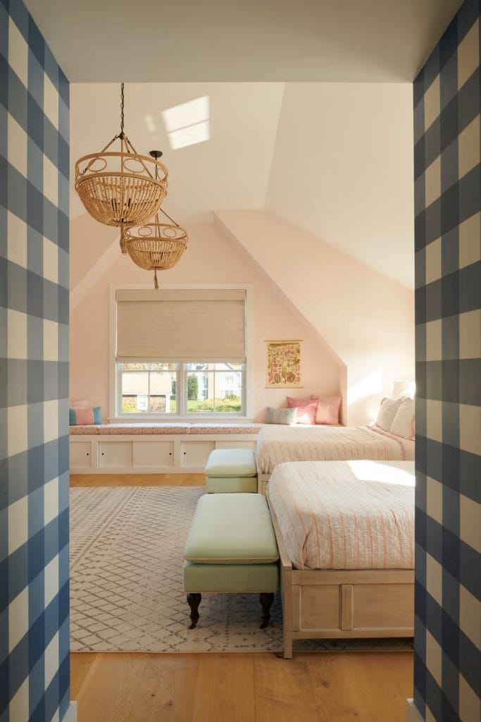 Soft pastel room with woven accents, a cozy window seat, and gentle decor.