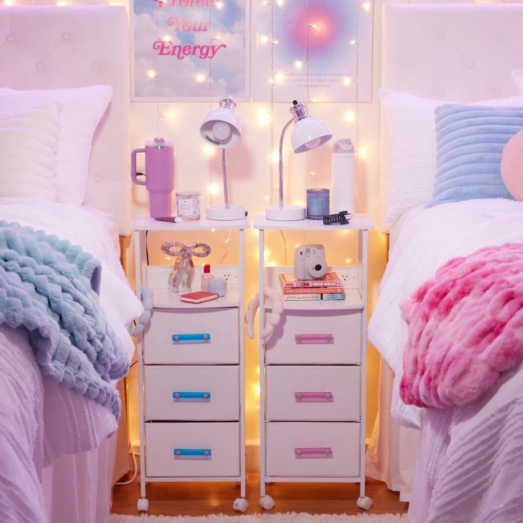 Dorm room with twin beds, colorful bedding, coordinated bedside tables, and string lights for a cozy ambiance.