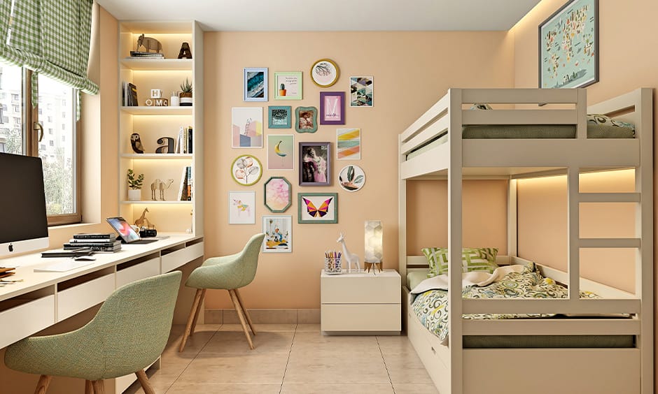 Dorm room with beige and pastel green decor, featuring bunk beds and a study area with shelves and framed art.