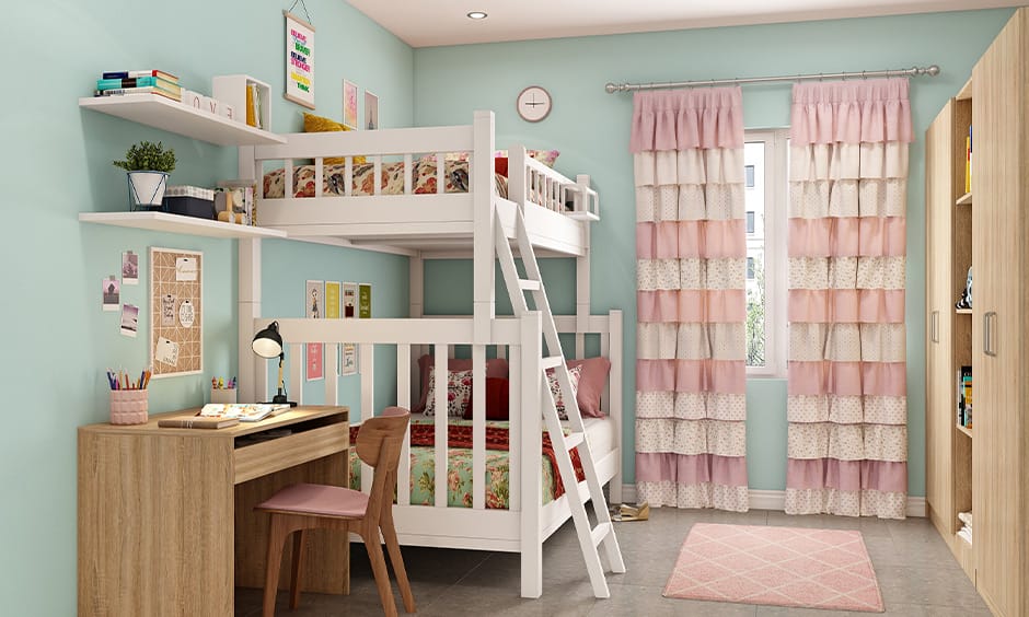 Dorm room with mint green and pink decor, featuring a bunk bed, desk, and lively wall art.