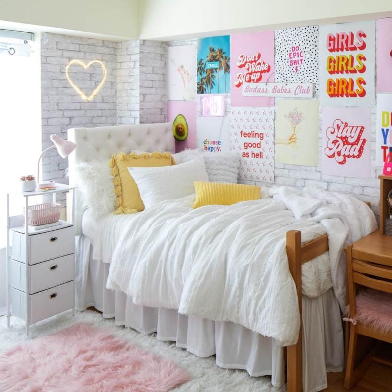 Vibrant dorm room with neon light and colorful posters.