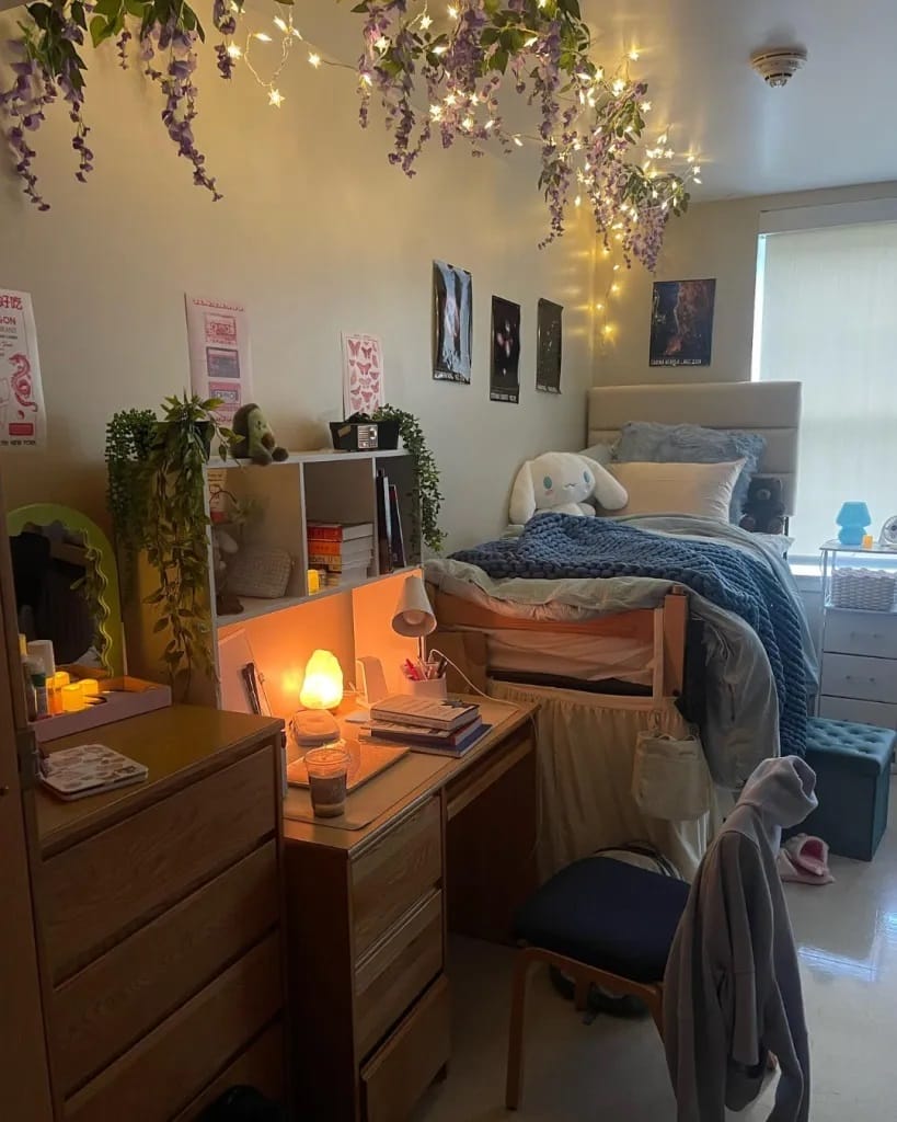 Bedroom with fairy lights, a cozy bed, and personal decor items.