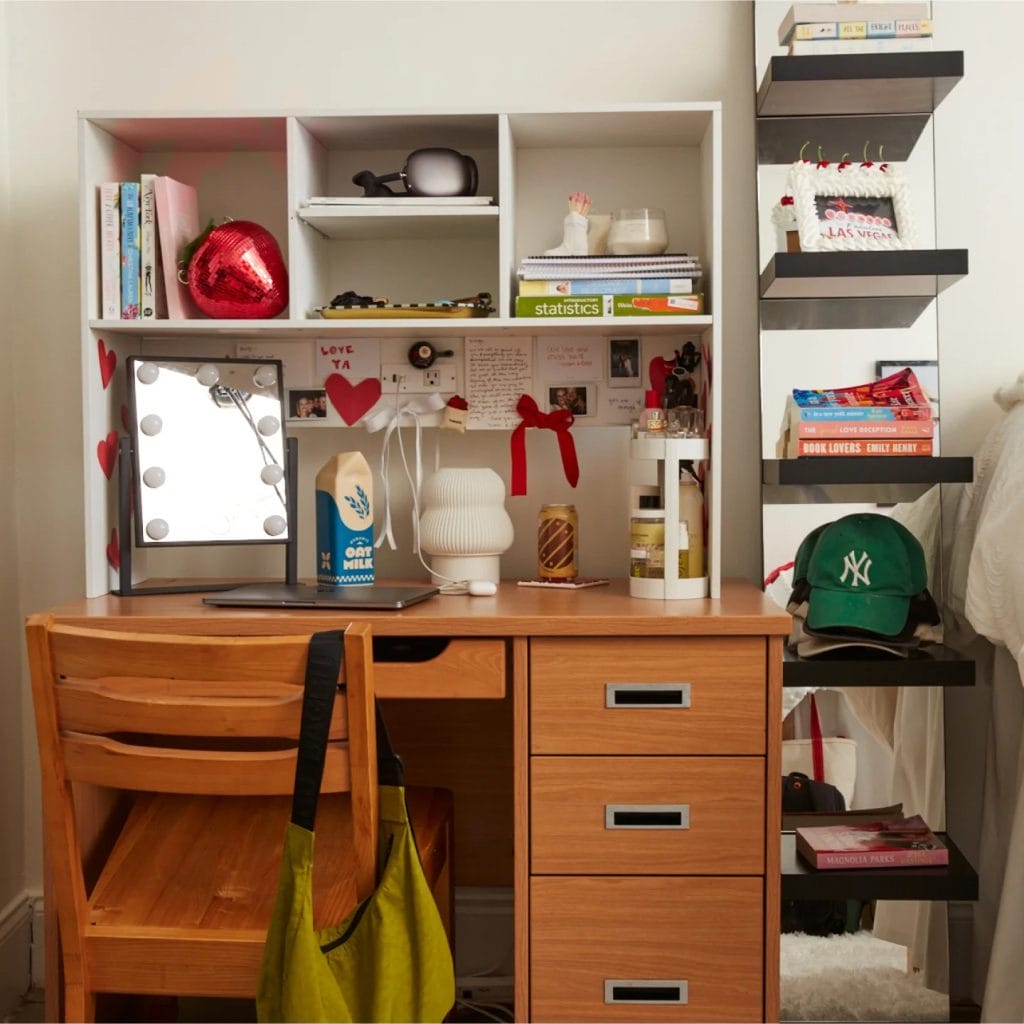 Study space with a wooden desk, ample storage, decorative shelves, and personalized touches.