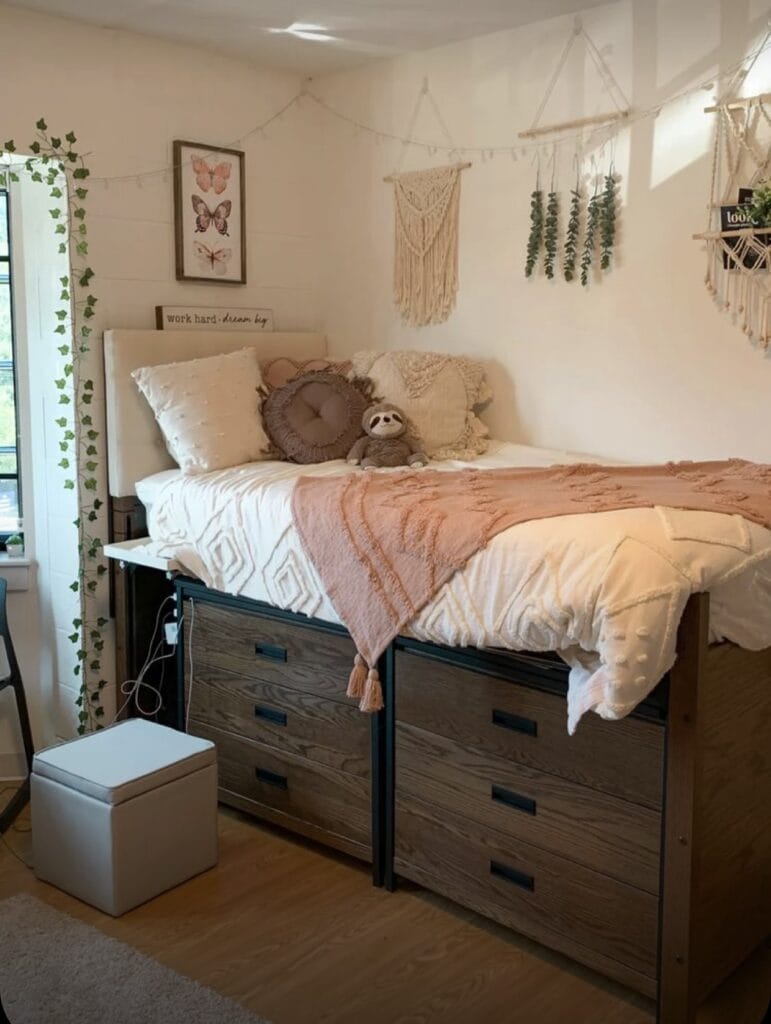 A boho-style dorm room with macrame wall hangings, hanging plants, and soft bedding.