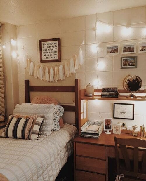 A modern dorm room with minimalist decor, neutral tones, and soft lighting.