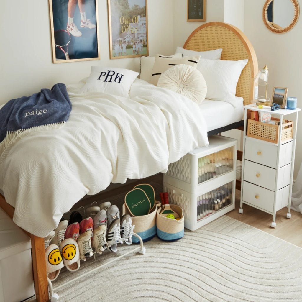 Room with organized storage, cozy bedding, stylish side table, and personalized decor.