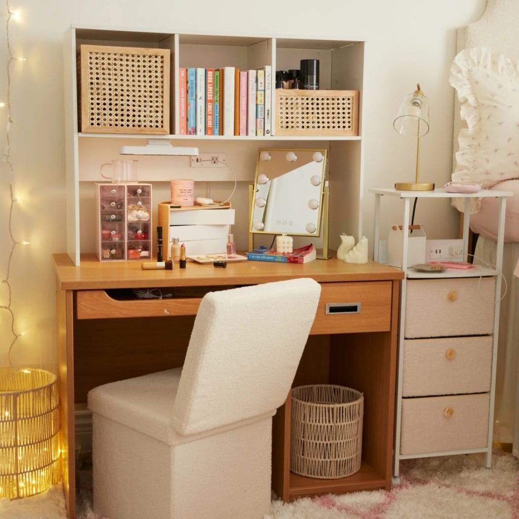 Functional dorm room study area with a wooden desk, shelves for storage, a comfortable chair, and string lights for ambiance.