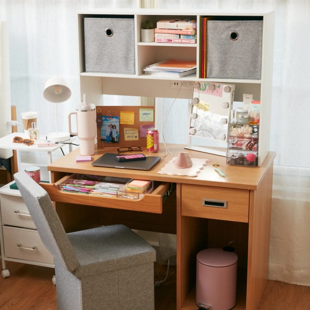 Organized study desk with soft pink and white accents.