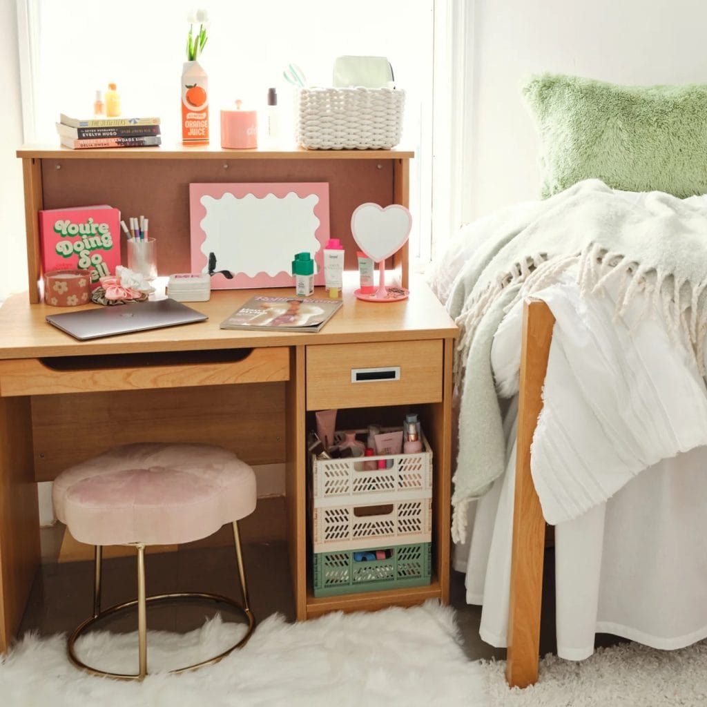 Stylish room with an organized study area, pastel colors, and fluffy bedding.