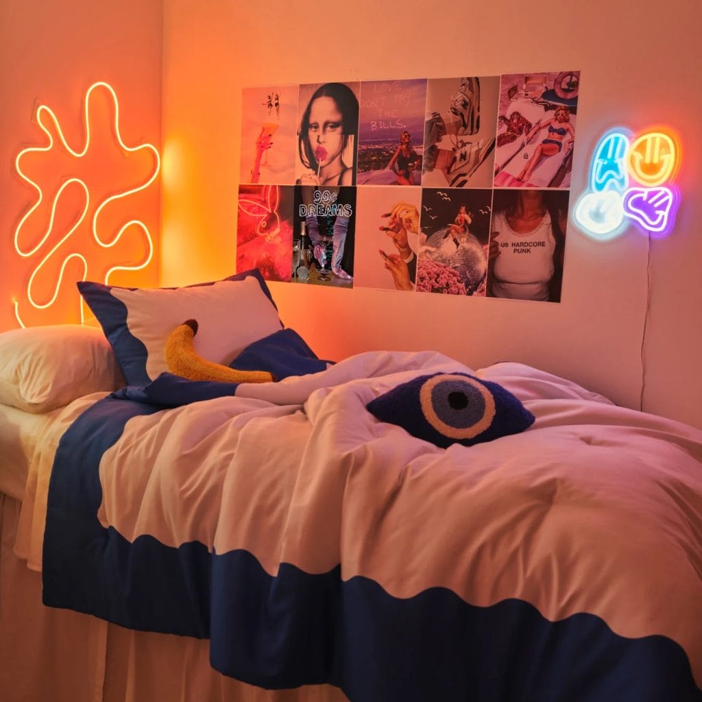 A lively room with neon lighting, featuring a bed with a white and blue duvet, colorful pillows, and a wall adorned with posters and neon signs.