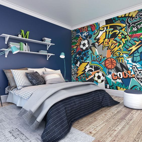 Teen boy's room with a graffiti art mural, navy blue walls, and modern furniture.