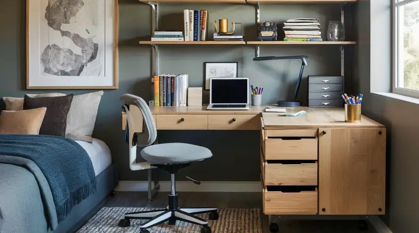 A teen boy’s room with a large desk area, storage shelves, and a cozy bed, combining study and relaxation.