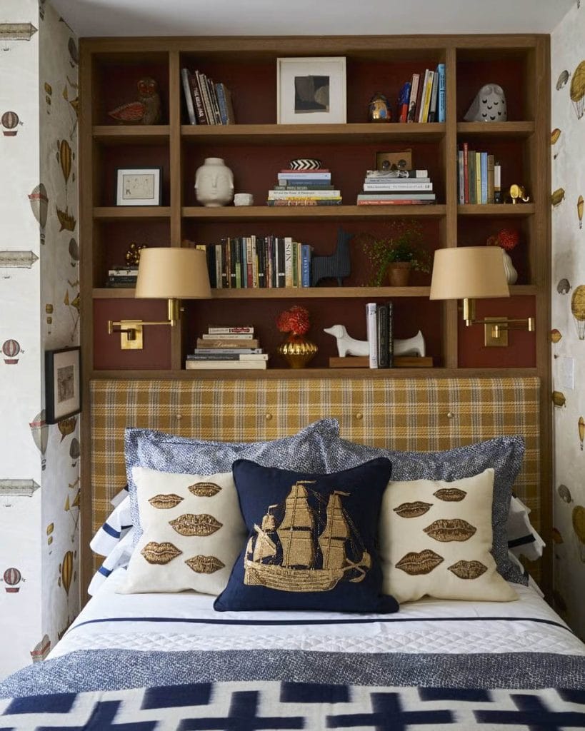 Teen boy's room with a built-in bookshelf, nautical-themed pillows, and cozy decor.