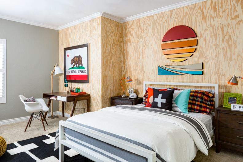 Teen boy's room with a rustic wood accent wall, colorful decor, and California-inspired artwork.