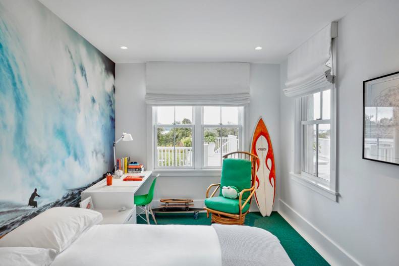 Teen boy's room with a wave mural, surfboard decor, and bright green accents.