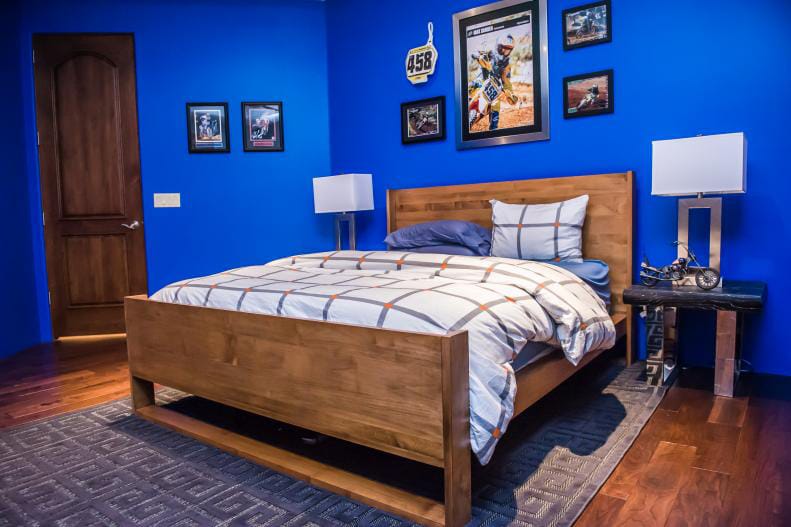 Bedroom with bright blue walls and wood furniture, creating a lively and energetic space.