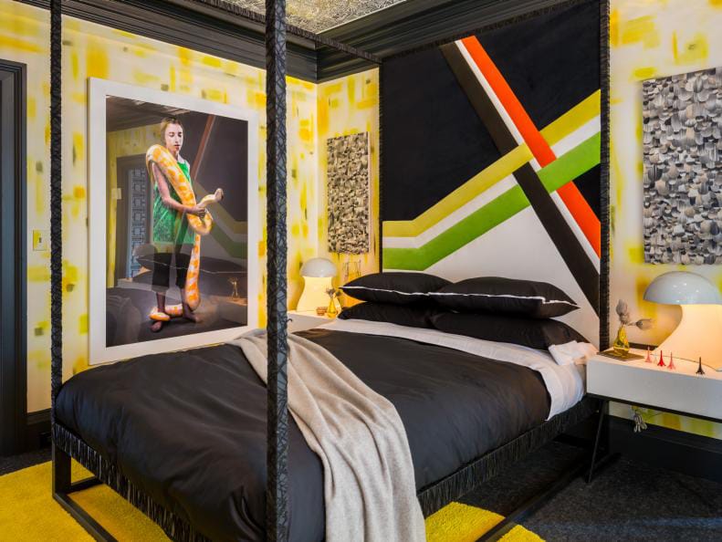 A teen bedroom with bold wall art, black and white bedding, and a mix of modern and abstract decor elements.