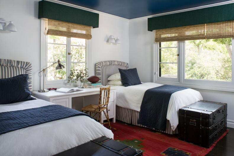 Nautical-themed bedroom with twin beds and navy accents.