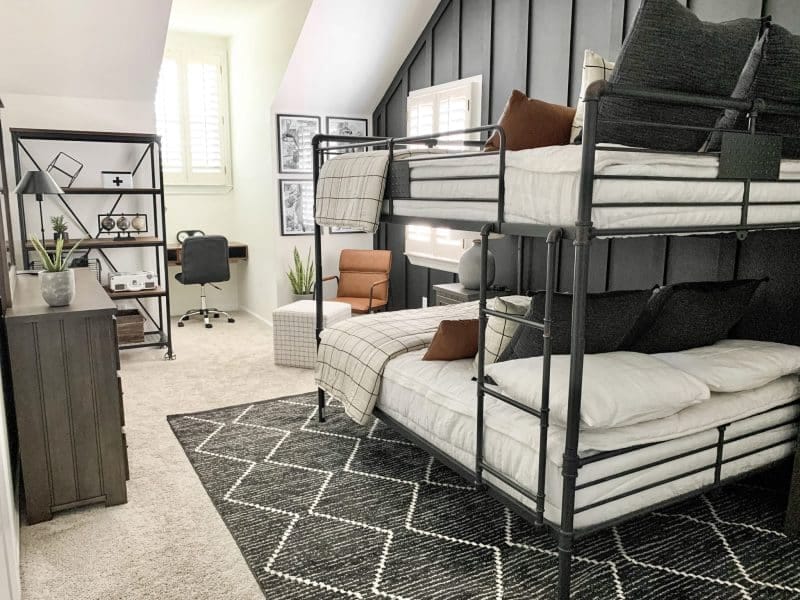 Industrial-style teen bedroom with metal bunk beds and a study area.