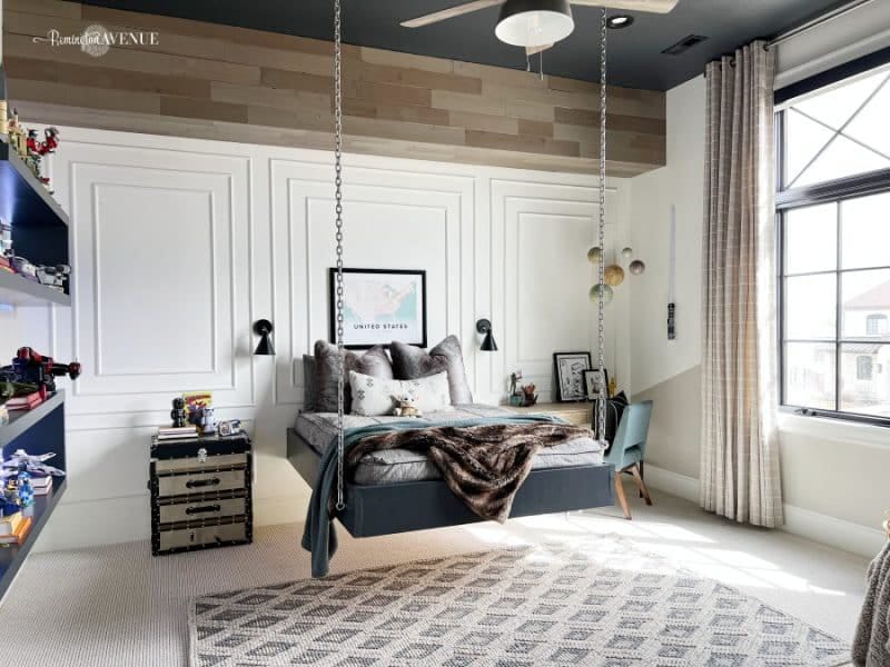 A teen bedroom with a hanging bed, neutral tones, and industrial-inspired decor.