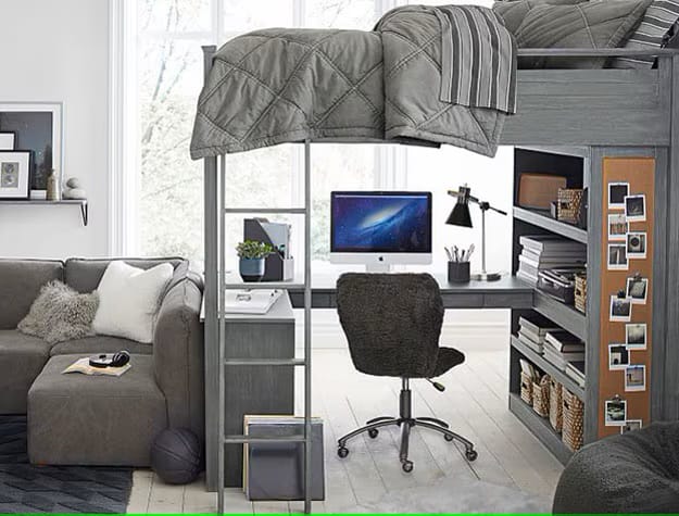 Loft bed with a gray color scheme and cozy seating area in a teen boy's room.