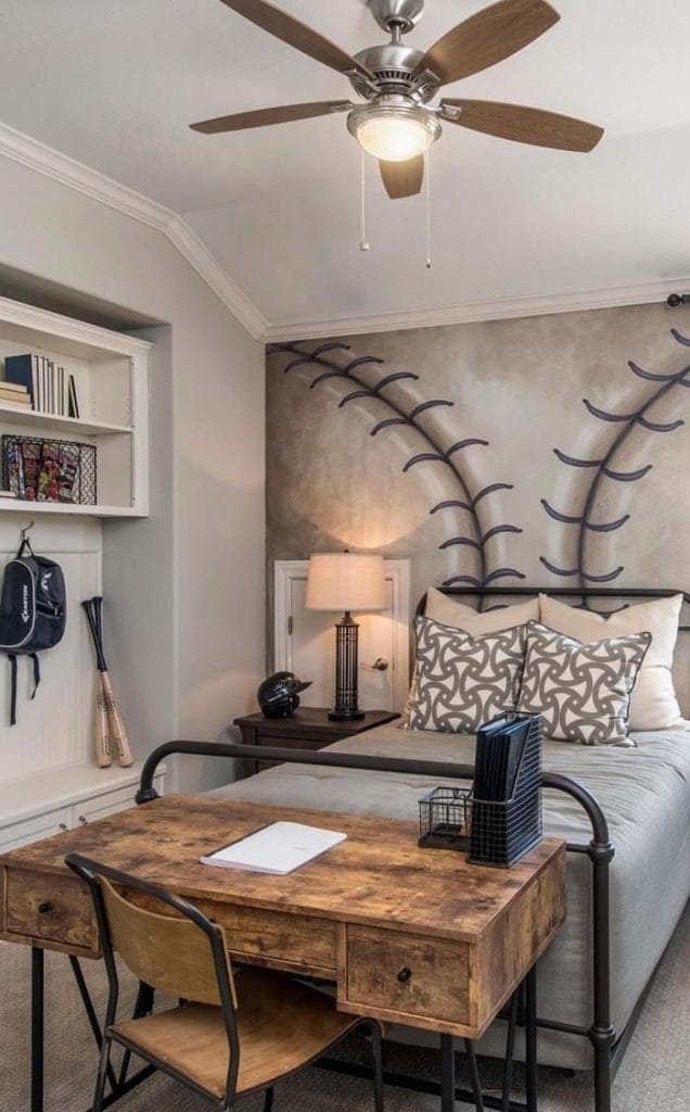 A teen boy's bedroom with a baseball-themed wall mural and rustic desk.