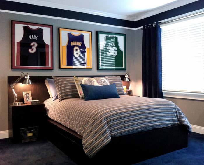 A teen boy's bedroom with framed basketball jerseys and striped bedding.