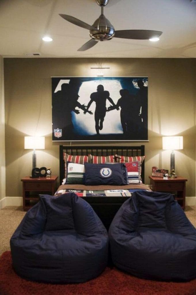 Football-themed bedroom with bean bags, a bed, and dramatic wall art above the bed.