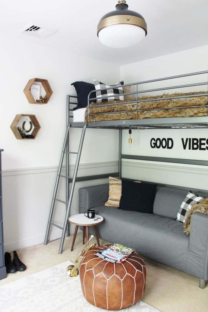 Loft bed with "Good Vibes" wall decor, gray sofa, and modern design elements.