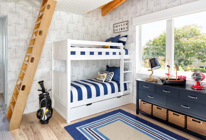 Nautical-themed bedroom with white bunk bed and blue decor.