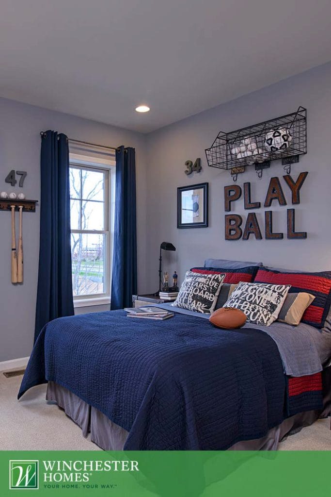 Sports-themed bedroom with dark blue and red decor.