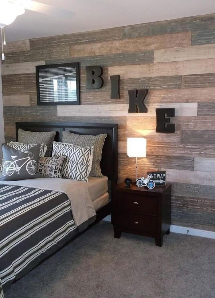 A cycling-themed room with "BIKE" letters on the wall and a rustic wood accent wall.